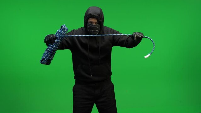 Masked hooded man with rope in green screen