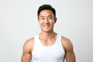 Portrait photography of a Vietnamese man in his 30s wearing a sporty tank top against a white background