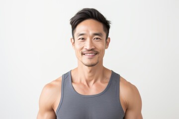 Portrait photography of a Vietnamese man in his 30s wearing a sporty tank top against a white...
