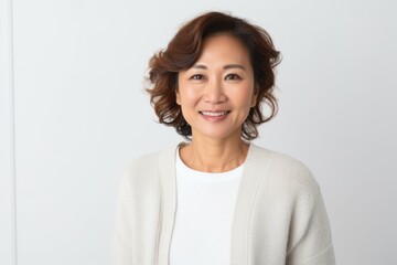 Fototapeta premium Portrait photography of a Vietnamese woman in her 40s against a white background