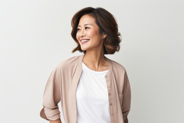 Obraz premium Lifestyle portrait photography of a Vietnamese woman in her 40s against a white background