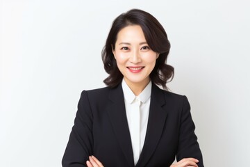 Obraz premium Lifestyle portrait photography of a Vietnamese woman in her 40s wearing a sleek suit against a white background