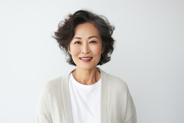 Fototapeta premium Portrait photography of a Vietnamese woman in her 50s against a white background