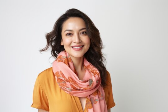 Portrait photography of a Vietnamese woman in her 30s wearing a charming scarf against a white background