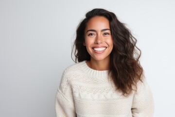 Medium shot portrait photography of a Peruvian woman in her 30s wearing a cozy sweater against a white background