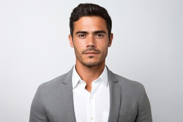 Portrait photography of a serious Peruvian man in his 30s against a white background