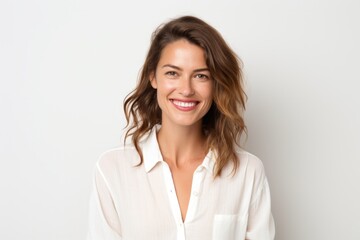 Portrait photography of a French woman in her 30s wearing a simple tunic against a white background - obrazy, fototapety, plakaty