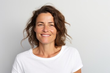 Portrait photography of a French woman in her 40s wearing a casual t-shirt against a white background