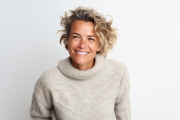 Portrait photography of a French woman in her 40s wearing a cozy sweater against a white background
