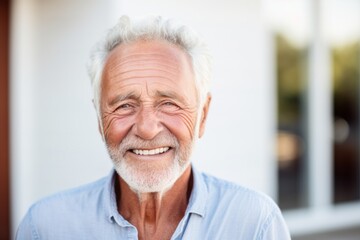 Portrait photography of a French man in his 80s wearing a simple tunic against a white background - obrazy, fototapety, plakaty