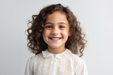 Portrait photography of a Colombian child female against a white background