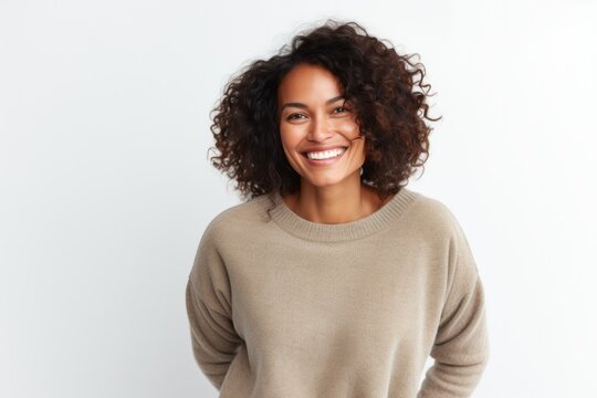 Portrait photography of a Colombian woman in her 30s wearing a cozy sweater against a white background