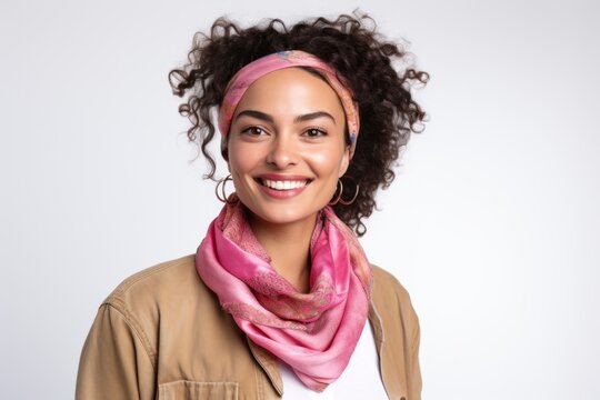 Lifestyle portrait photography of a Colombian woman in her 30s wearing a charming scarf against a white background