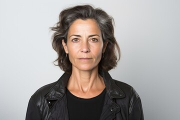 Portrait photography of a serious Italian woman in her 50s against a white background