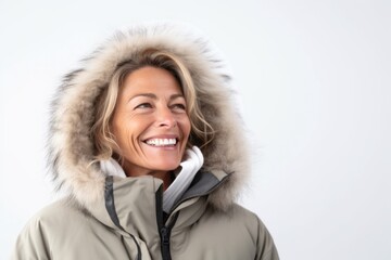 Medium shot portrait photography of a Italian woman in her 50s wearing a warm parka against a white background