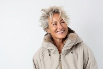 Medium shot portrait photography of a Italian woman in her 50s wearing a warm parka against a white background