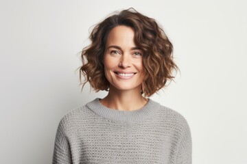 Fototapeta premium Portrait photography of a Swedish woman in her 30s wearing a cozy sweater against a white background