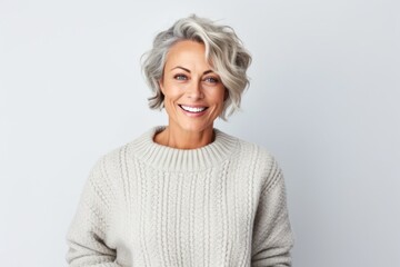 Medium shot portrait photography of a Swedish woman in her 50s wearing a cozy sweater against a white background