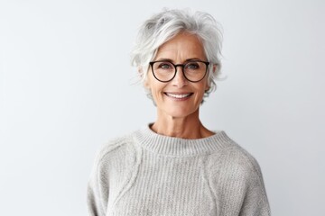 Medium shot portrait photography of a Swedish woman in her 60s wearing a cozy sweater against a white background