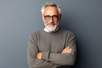 Medium shot portrait photography of a French man in his 80s wearing a cozy sweater against a minimalist or empty room background