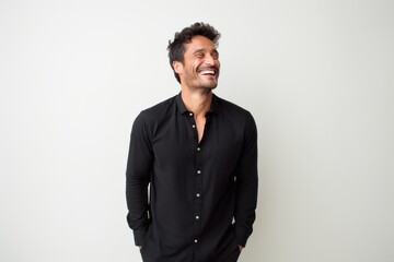Fototapeta premium Lifestyle portrait photography of a cheerful Colombian man in his 30s against a minimalist or empty room background