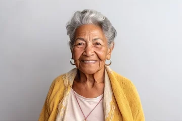 Fotobehang Medium shot portrait photography of a 100-year-old elderly Colombian woman against a minimalist or empty room background © Anne Schaum
