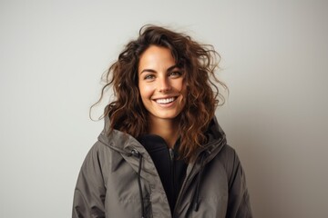 Obraz premium Portrait photography of a Italian woman in her 30s wearing a warm parka against a minimalist or empty room background