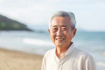 Fototapeta na wymiar Medium shot portrait photography of a Vietnamese man in his 80s against a beach background