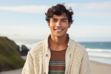 Medium shot portrait photography of a Peruvian man in his 20s against a beach background