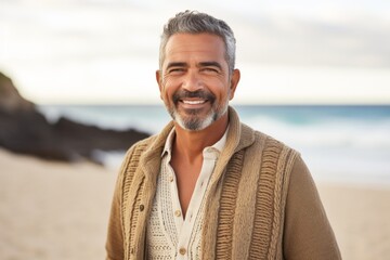 Medium shot portrait photography of a Colombian man in his 50s against a beach background