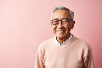 Portrait photography of a Vietnamese man in his 90s against a pastel or soft colors background