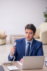 Young male employee working in the office