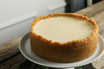 Tasty vegan tofu cheesecake on wooden table