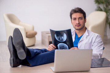 Young doctor radiologist sitting at the hospital