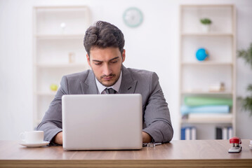 Young male employee working in the office
