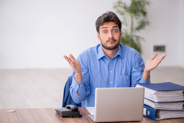 Young male employee working in the office