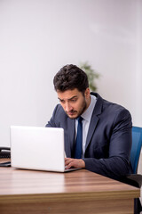 Young male employee working in the office