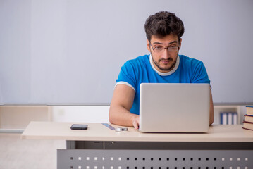 Young male student in telestudying concept