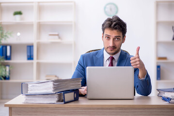 Young male employee working in the office