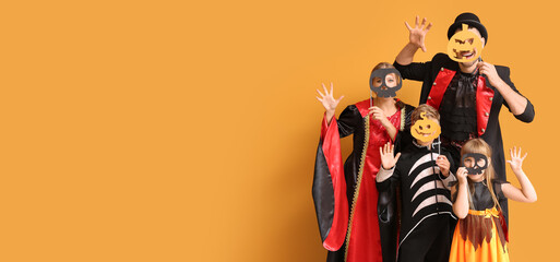 Family in Halloween costumes on orange background with space for text