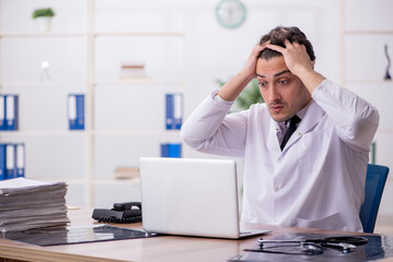 Young male doctor in telemedicine concept