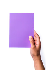 A human hand holding a blank sheet of purple paper or card isolated on a white background