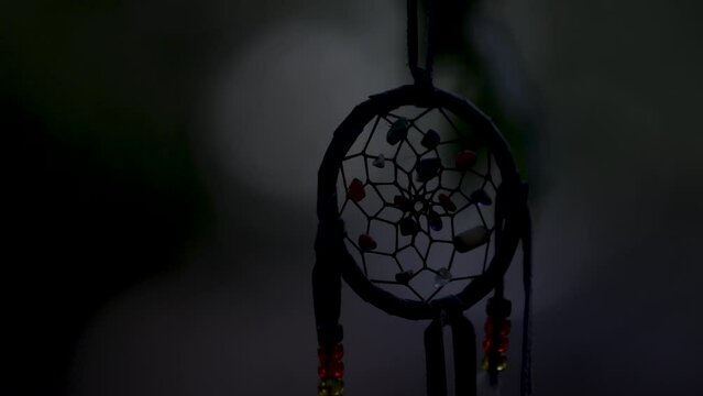 Dreamcatcher at nigh, dark mood scene. Horror movie detail, nightmare concept