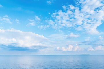 Naklejka na ściany i meble Sea or ocean with a blue sky and white clouds 