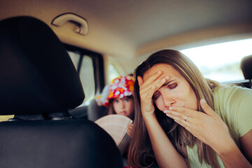 Mom Traveling by Car Feeling Sick in the Back Seat. Mother feeling dizzy and nauseated from carsick symptoms 
