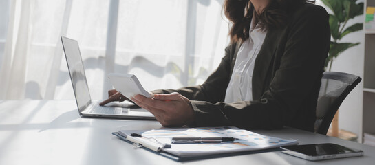 Financial Business woman analyze the graph of the company's performance to create profits and growth, Market research reports and income statistics, data,repotr,Financial and Accounting concept.