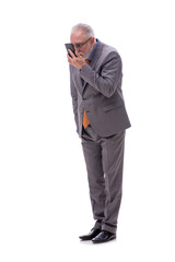 Old businessman talking by phone isolated on white