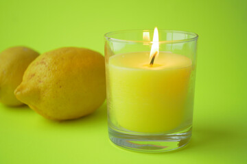 yellow color candle and lemon on black background 