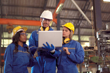 Team of mechanical engineer working together in the factory, engineers inspecting a metal machine system the factory.