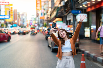 Young Asian tourists standing selfie taking a photo. Young woman beautiful tourists in Chinatown...